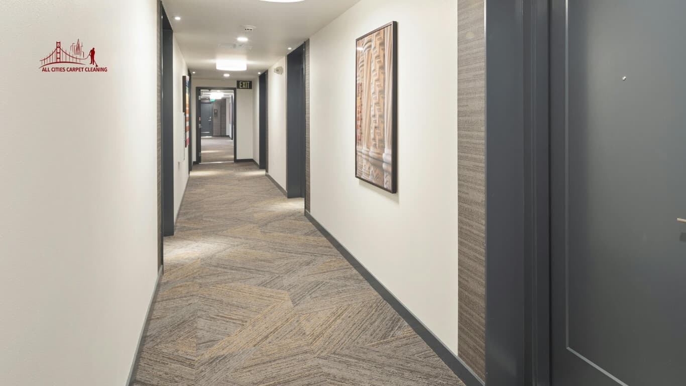 Carpeted hallway in apartment complex with many apartment doors and hallway lights representing property management services like carpet cleaning and maintenance services